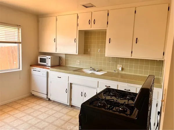 a kitchen with a sink stove and cabinets