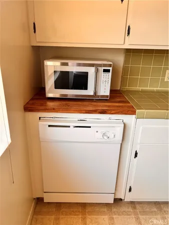 a stove top oven sitting inside of a kitchen