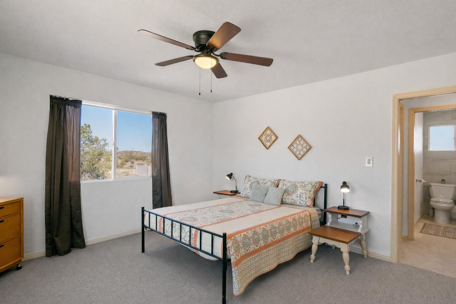 5096 Old Woman Springs Road Johnson Valley, CA 92285 - Photo 12 of 42 a bedroom with a bed and a chandelier