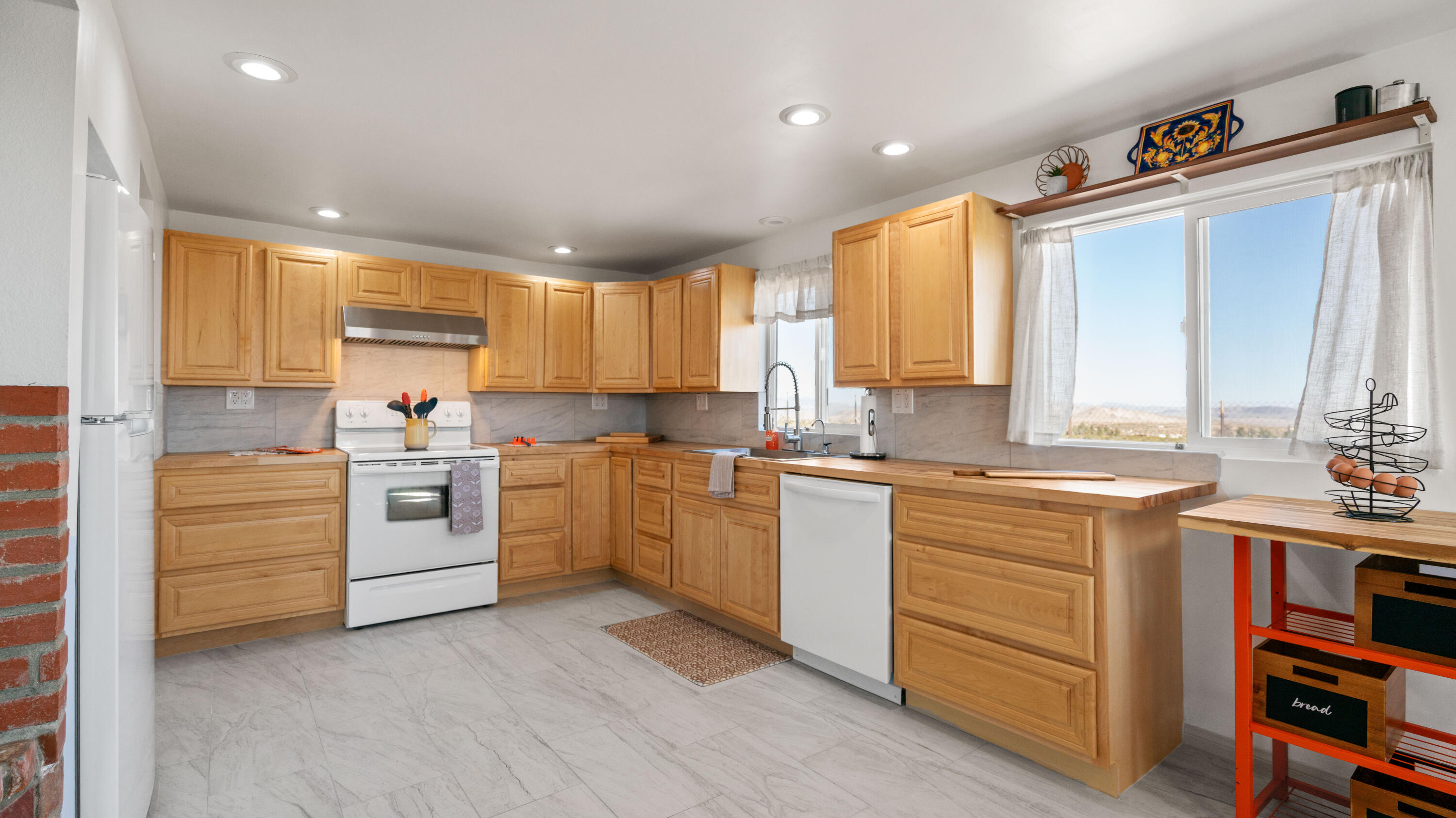5096 Old Woman Springs Road Johnson Valley, CA 92285 - Photo 6 of 42 a kitchen with a sink window and cabinets