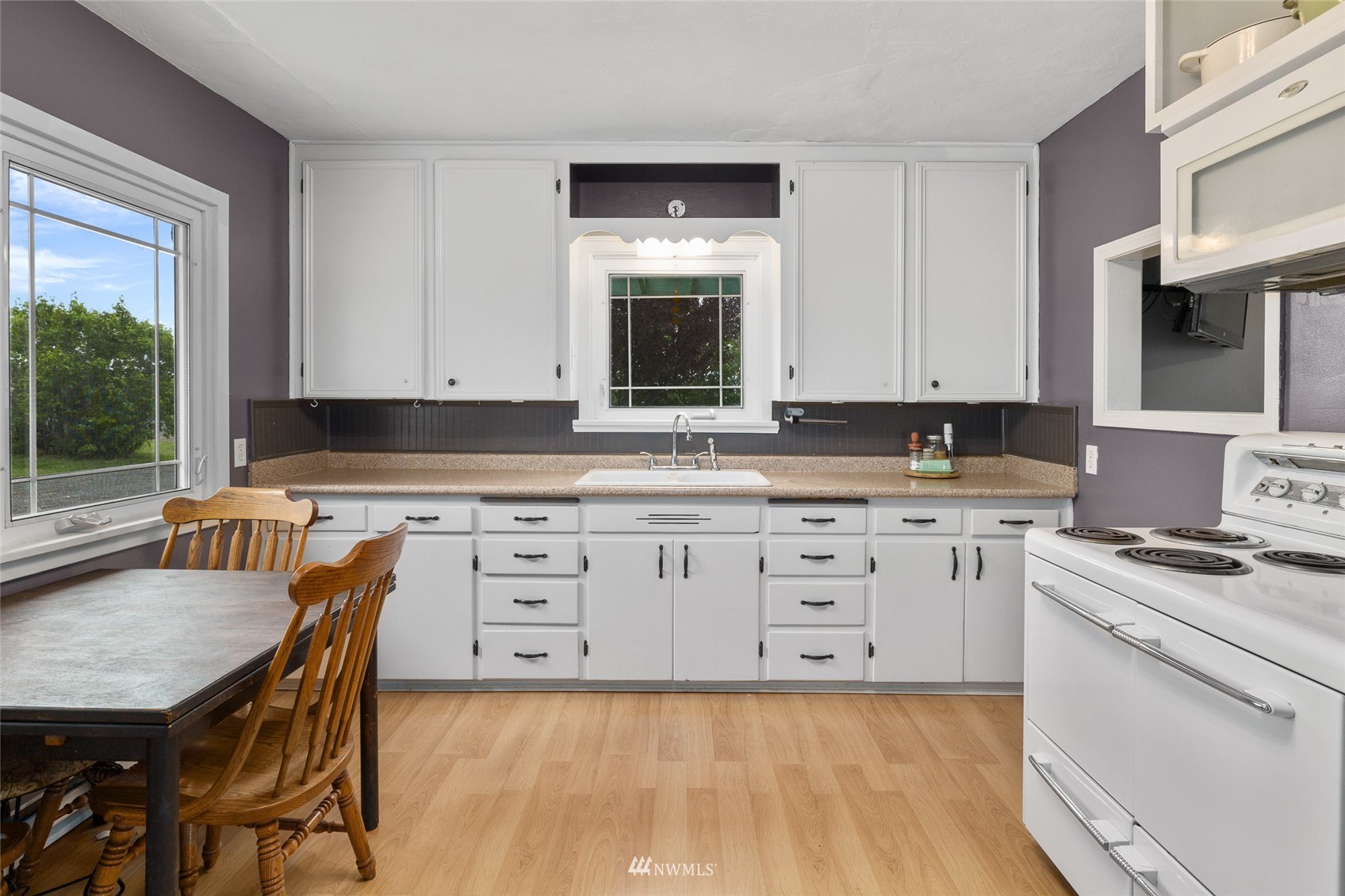 7811 4th Parallel Road Ellensburg, WA 98926 - Photo 13 of 32 a kitchen with granite countertop a stove a sink and a granite counter tops