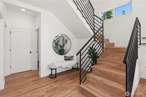 a view of a hallway with wooden floor and entryway