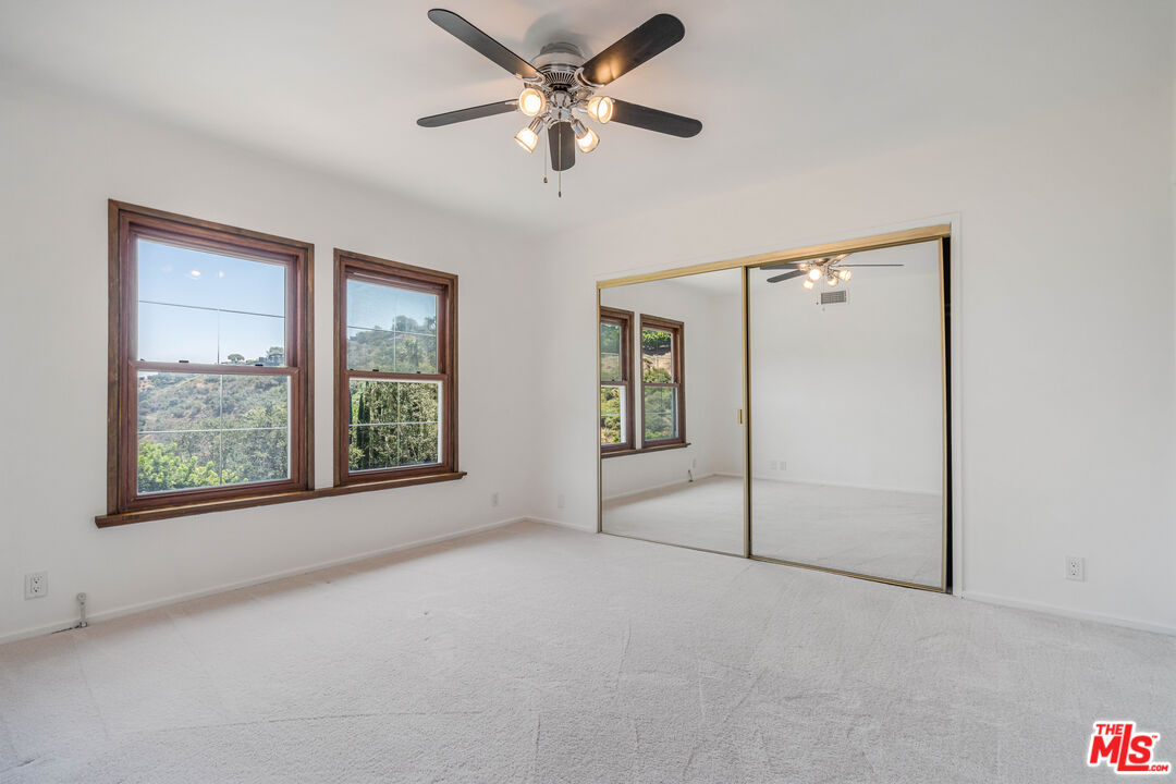 1181 Somera Road Los Angeles, CA 90077 - Photo 24 of 40 an empty room with fan and windows