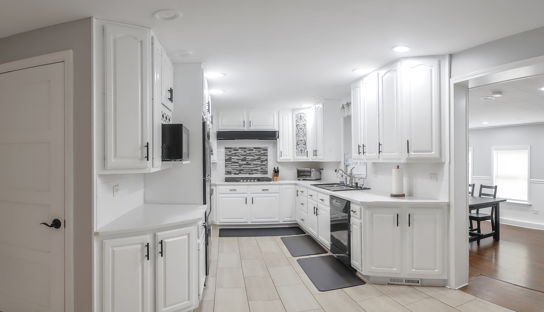 227 North Butterfield Road Libertyville, IL 60048 - Photo 12 of 27 a kitchen with a white cabinets and chairs