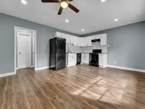 a view of a kitchen with a sink and a refrigerator