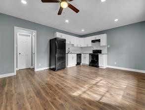 a view of a kitchen with a sink and a refrigerator