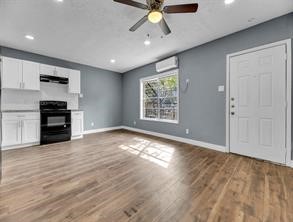 5911 Grace Lane, Unit 2 Houston, TX 77021 - Photo 2 of 7 an empty room with wooden floor ceiling fan and windows