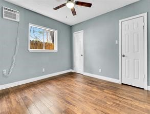 5911 Grace Lane, Unit 2 Houston, TX 77021 - Photo 5 of 7 a view of an empty room with window and wooden floor