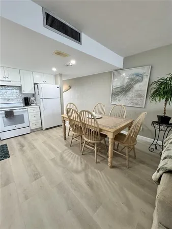 a dining room with furniture and a kitchen view