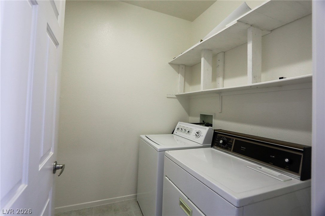 6472 Centennial Road Pahrump, NV 89048 - Photo 11 of 29 Functional laundry area featuring convenient shelving for organization and essential appliances.