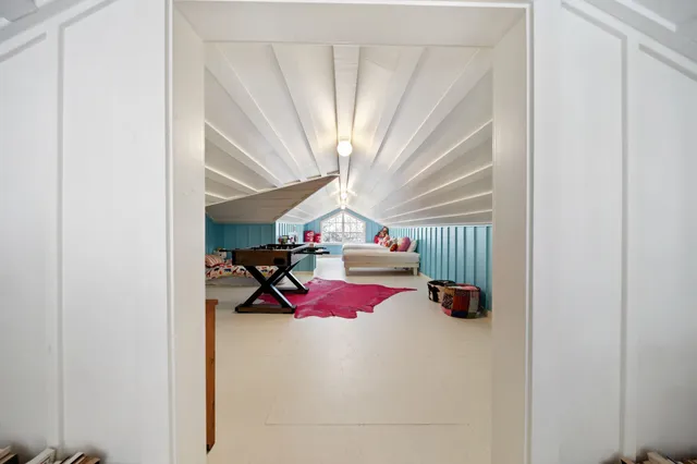 a bedroom with furniture and a chandelier