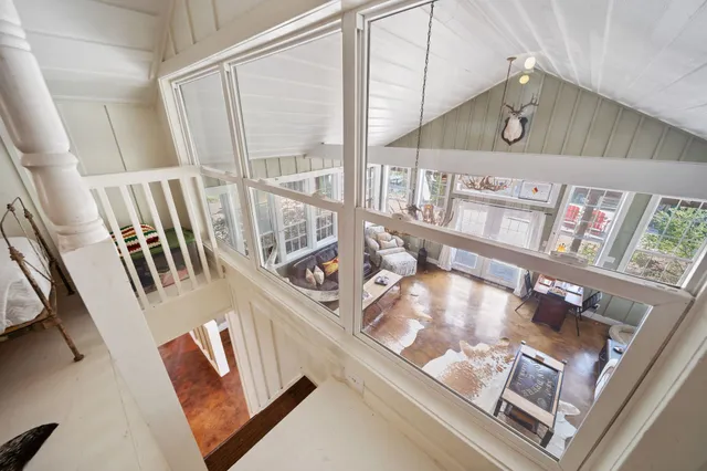 a view of a hallway with shelf with books and knick knacks on it