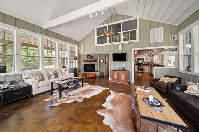 a living room with furniture fireplace and flat screen tv