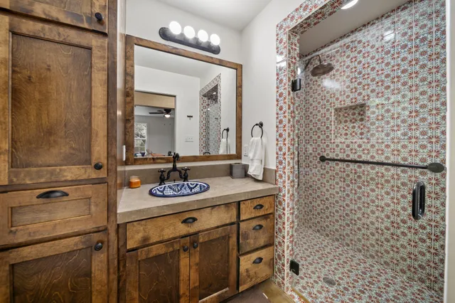 a bedroom with furniture a large window and a fireplace