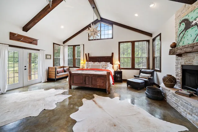 a bedroom with furniture and a large window