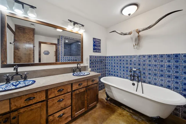 a spacious bathroom with a bathtub and a sink