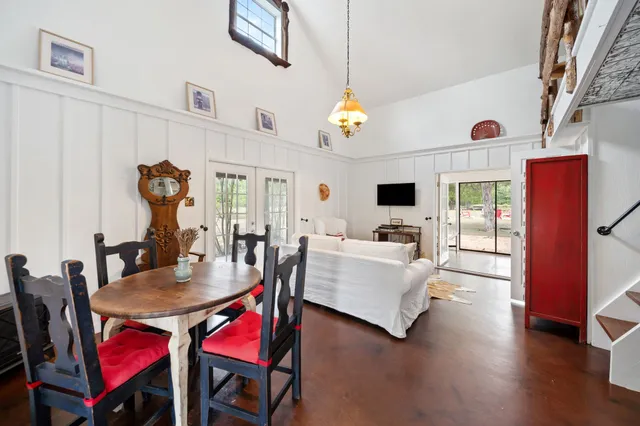 a living room with furniture a rug and a chandelier