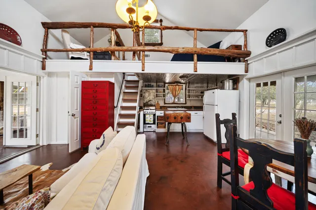 a view of a kitchen with furniture and wooden floor