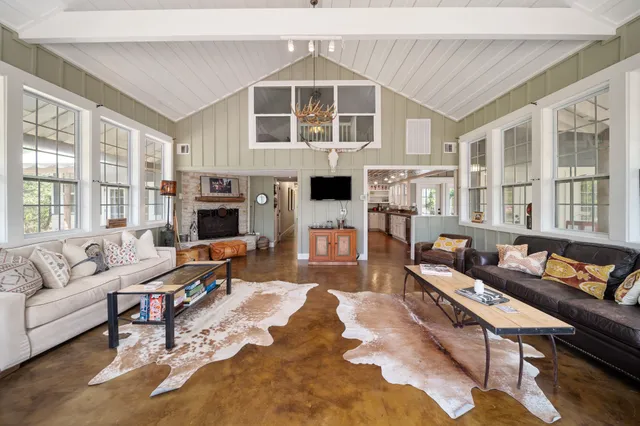 a living room with furniture and large windows