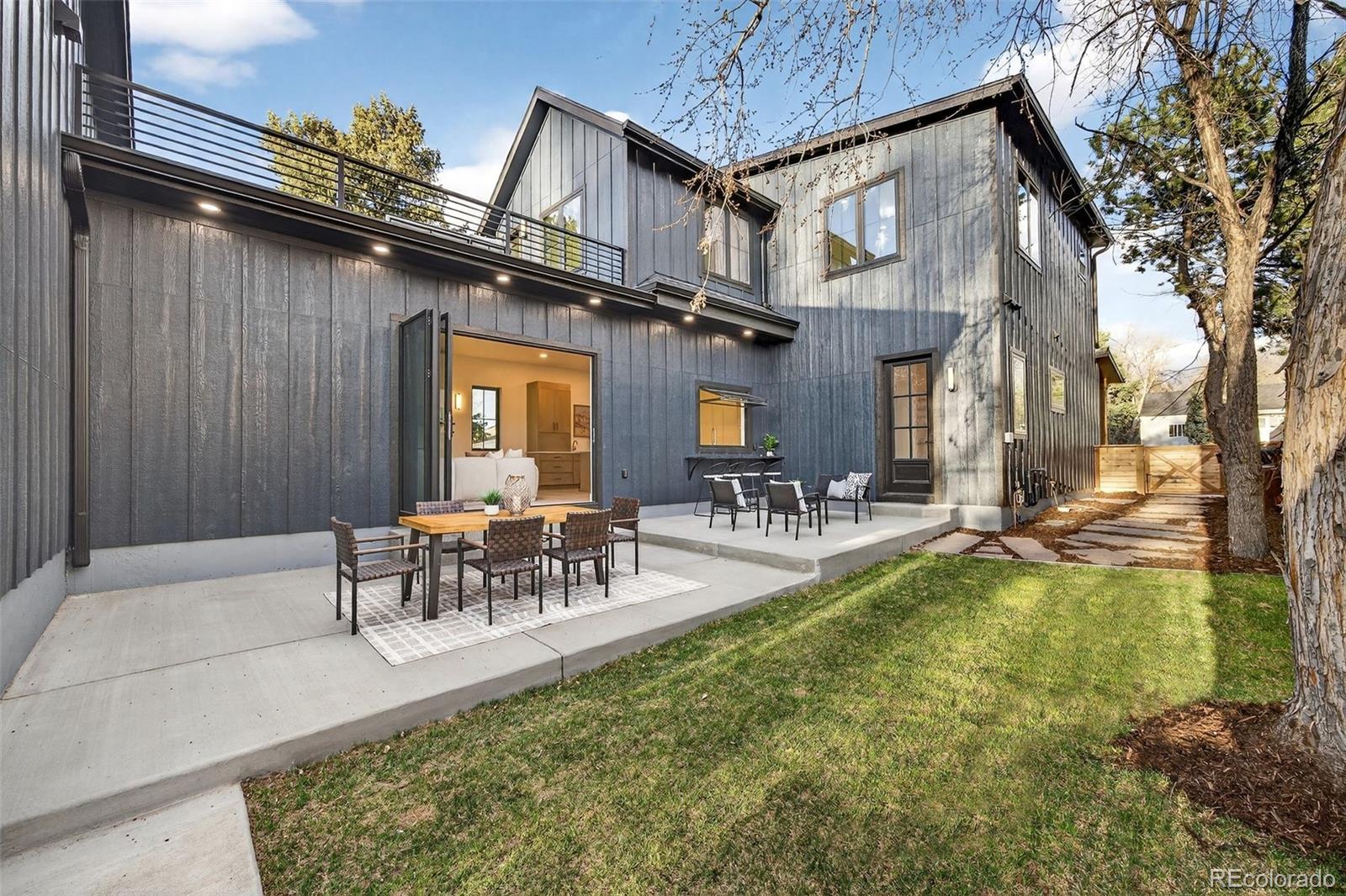 5175 Raleigh Street Denver, CO 80212 - Photo 2 of 49 a view of a swimming pool with table and chairs