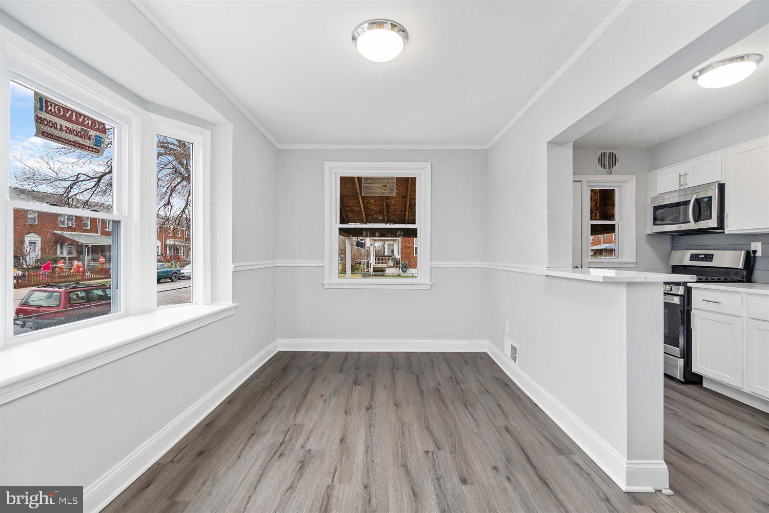 8419 Kavanagh Road Baltimore, MD 21222 - Photo 12 of 31 a view of a kitchen with wooden floor and electronic appliances