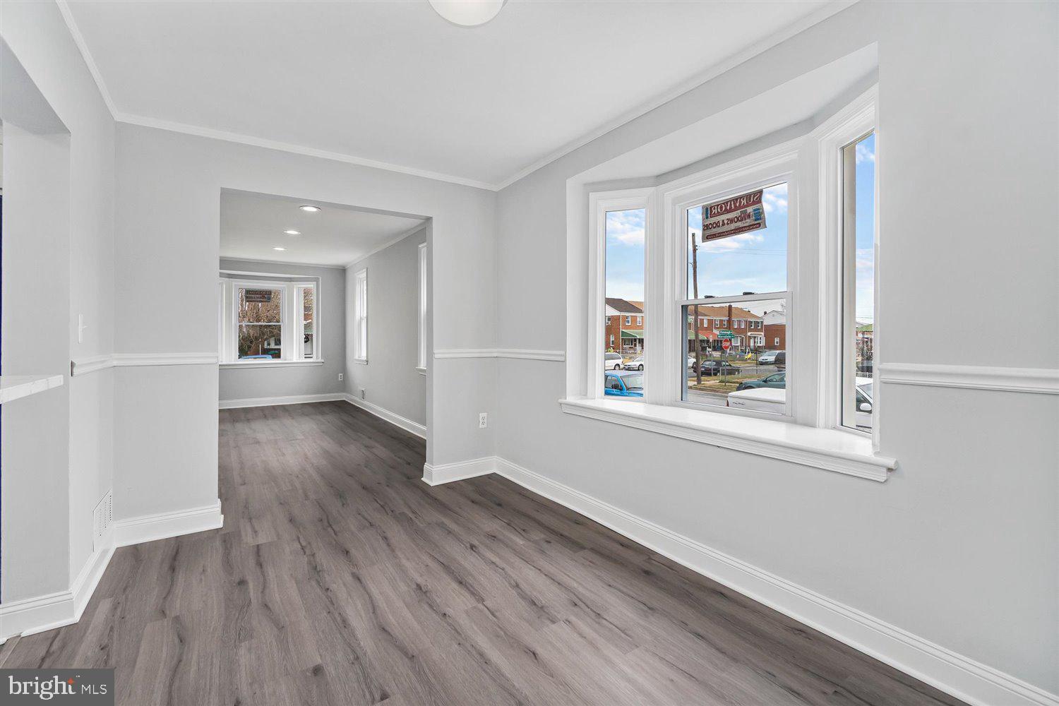 8419 Kavanagh Road Baltimore, MD 21222 - Photo 13 of 31 an empty room with wooden floor and windows