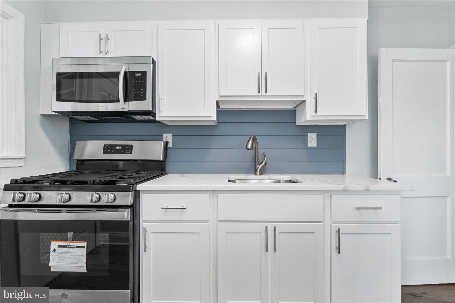 8419 Kavanagh Road Baltimore, MD 21222 - Photo 15 of 31 a kitchen with appliances a sink and cabinets