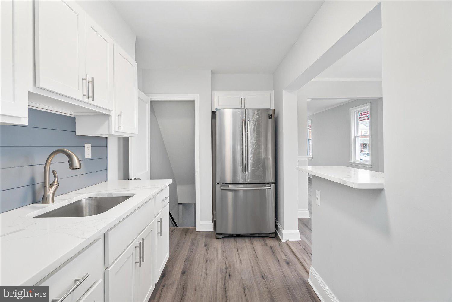 8419 Kavanagh Road Baltimore, MD 21222 - Photo 17 of 31 a kitchen with a refrigerator sink and cabinets
