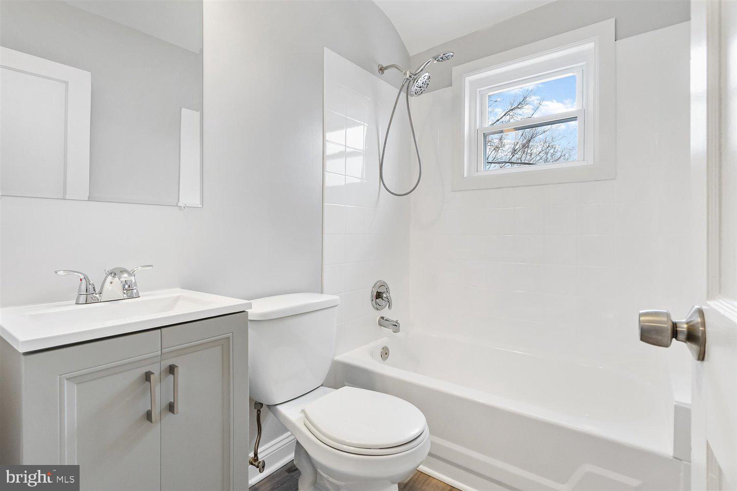8419 Kavanagh Road Baltimore, MD 21222 - Photo 26 of 31 a bathroom with a toilet sink and mirror