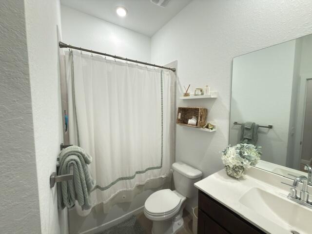 19696 Weathervane Way Loxahatchee, FL 33470 - Photo 29 of 39 a bathroom with a sink a toilet and a mirror