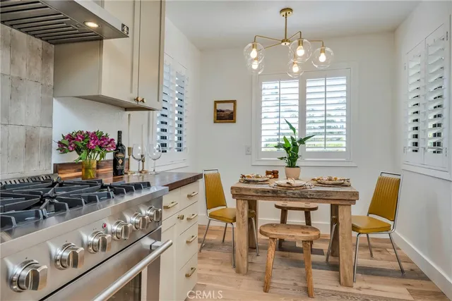 a view of a dining room with furniture and chandelier