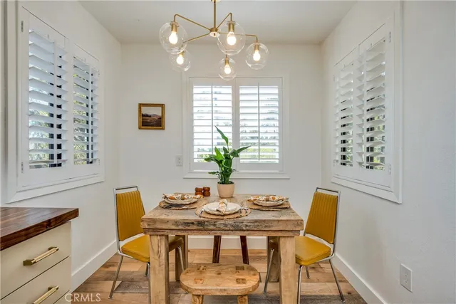 a view of a dining room with furniture and chandelier