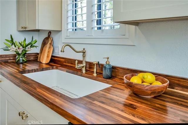a kitchen with a sink and a wooden floor