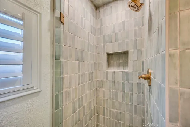 a bathroom with a granite countertop sink a potted plant and a window