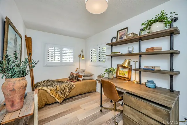 a bedroom with furniture and a mirror