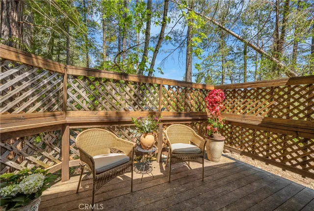 a view of balcony with floor to ceiling windows and wooden floor