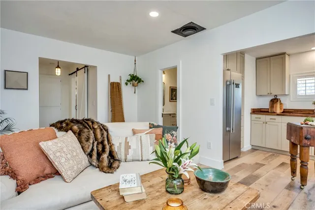 a bedroom with a bed potted plant with the mirror