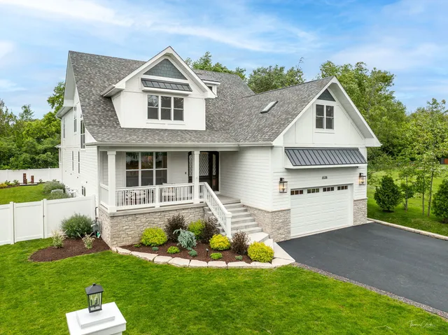 a front view of a house with a yard table and chairs