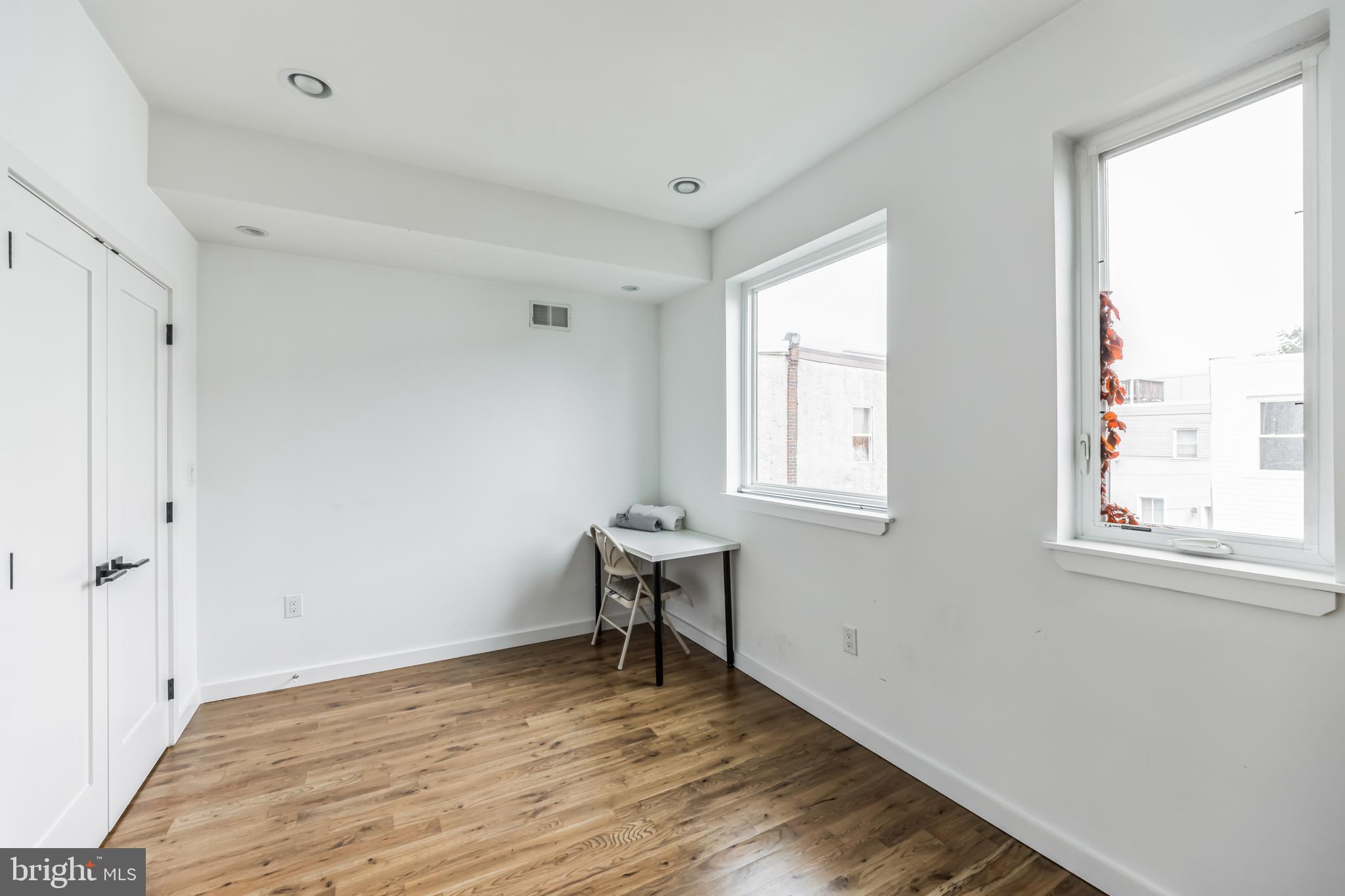 1943 Wilder Street Philadelphia, PA 19146 - Photo 12 of 43 a view of an empty room with wooden floor and a window