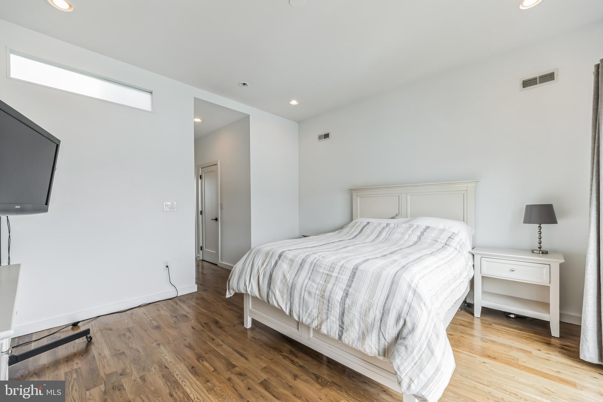 1943 Wilder Street Philadelphia, PA 19146 - Photo 19 of 43 a bedroom with a bed and a flat screen tv