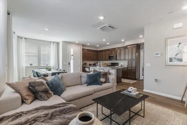 a living room with furniture and kitchen view