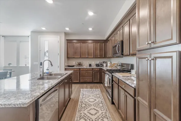 a kitchen with stainless steel appliances granite countertop lots of counter top space and a center island