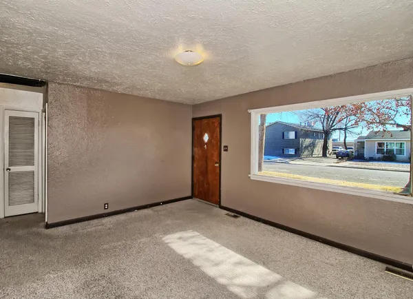 a view of an empty room with a window