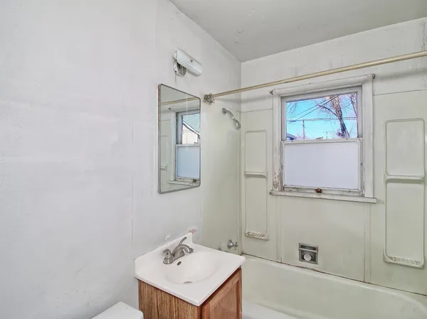a bathroom with a sink a mirror and a shower