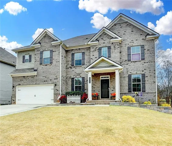 a view of a white house with swimming pool and windows