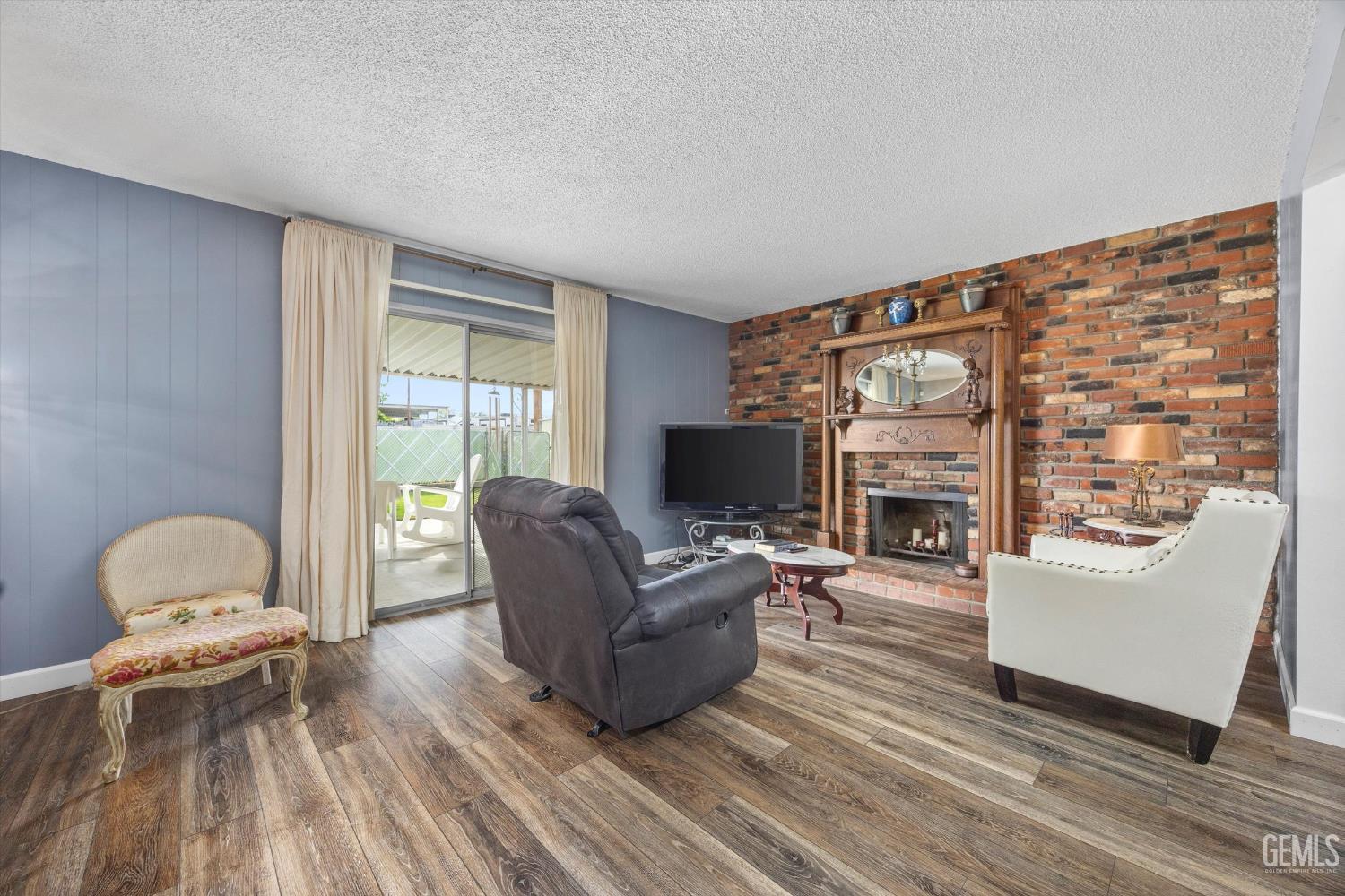Undisclosed Address Taft, CA 93268 - Photo 16 of 42 a living room with furniture and a flat screen tv