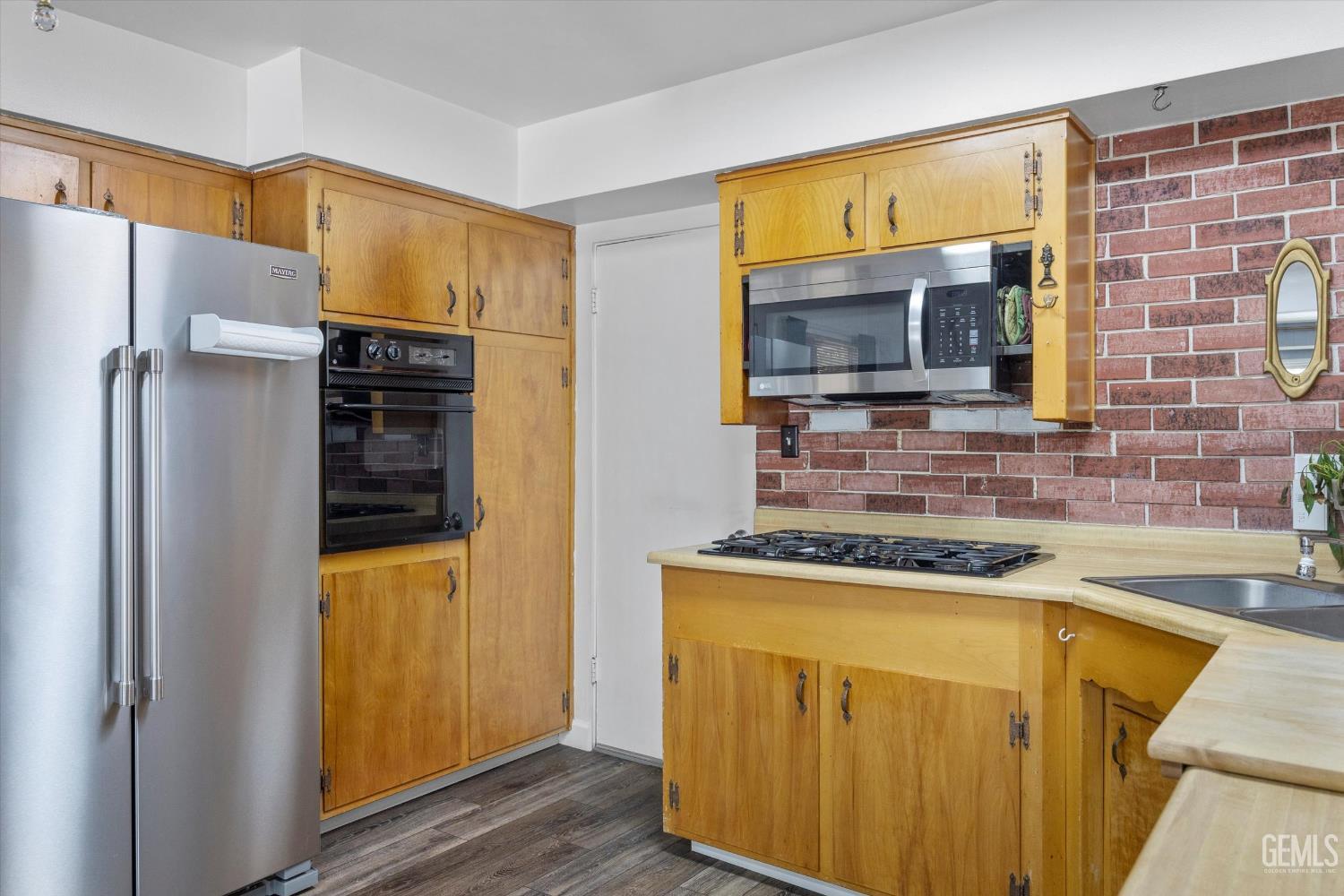 Undisclosed Address Taft, CA 93268 - Photo 29 of 42 a kitchen with a sink a refrigerator and cabinets
