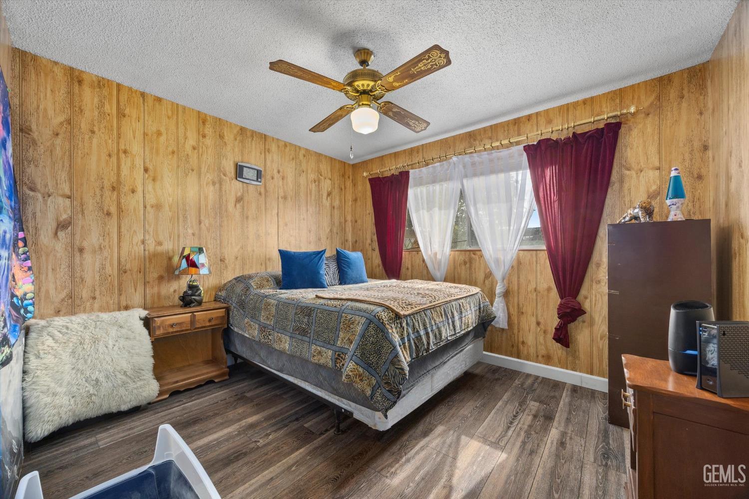 Undisclosed Address Taft, CA 93268 - Photo 30 of 42 a bedroom with a bed and wooden floor