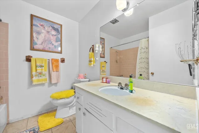 a bathroom with a granite countertop sink mirror and a bathtub