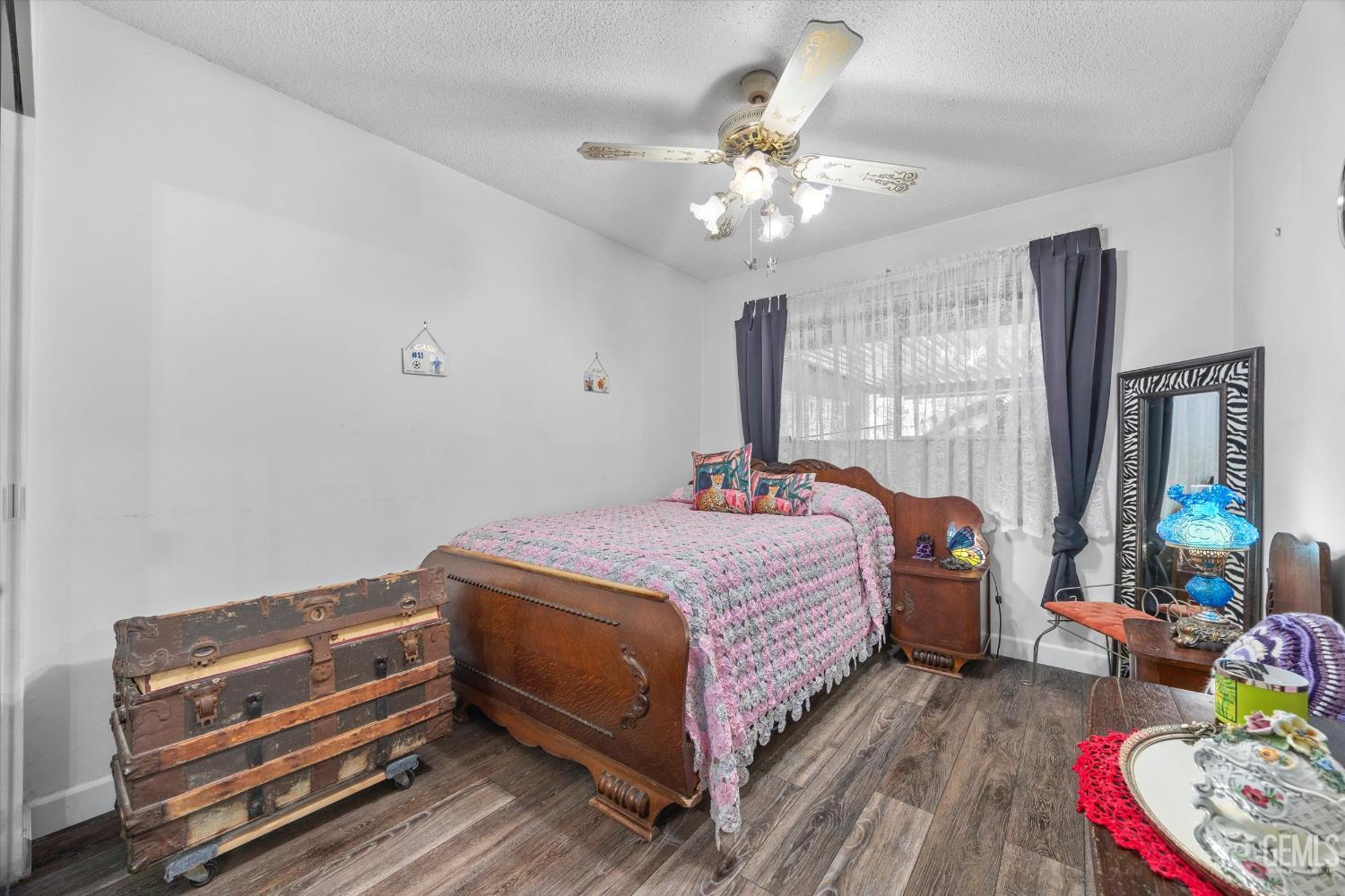 Undisclosed Address Taft, CA 93268 - Photo 35 of 42 a bedroom with a bed and a chandelier